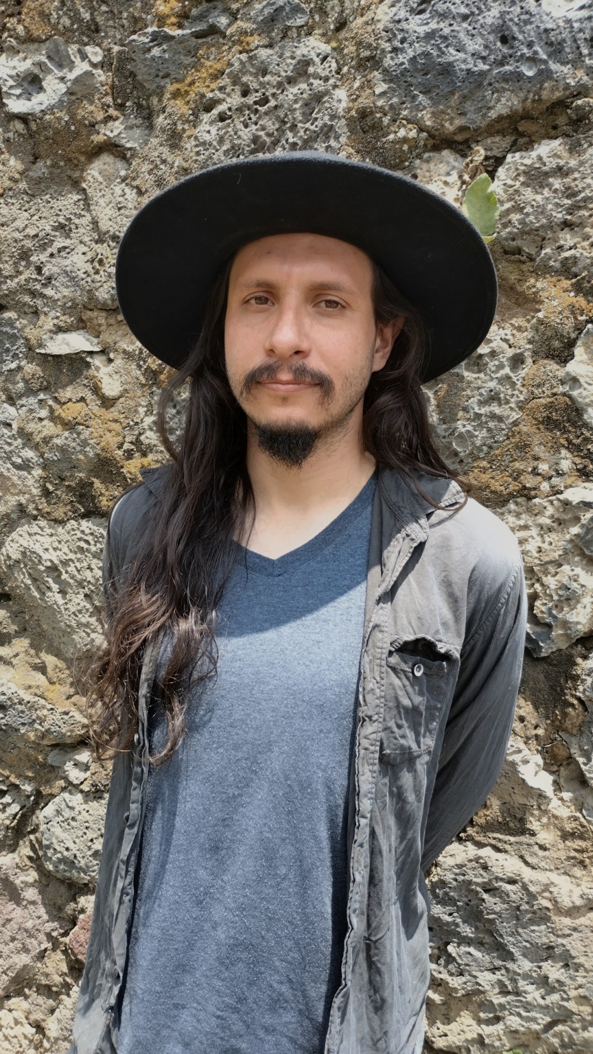 Portrait of Diego Madero against a stone wall